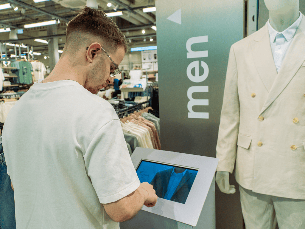 Client-utilise-borne-interactive-celio Client utilisant une borne interactive en magasin Celio